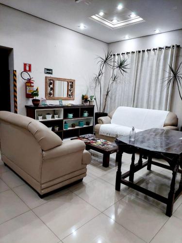 a living room with a couch and a coffee table at Hotel Excelsior in Poços de Caldas