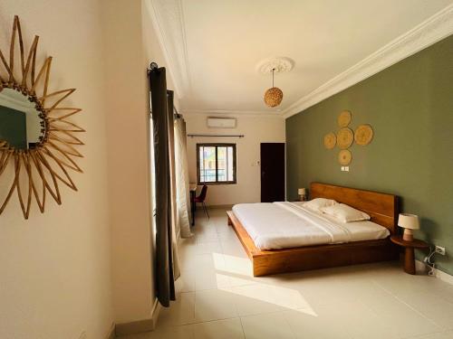 a bedroom with a bed in a room at Cocoon Guest House in Cotonou