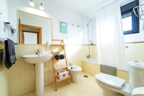 a bathroom with a sink and a toilet at Villa Colibri Dorado in Lajares