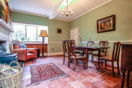 a dining room with a table and chairs at Garden House in North Lydbury