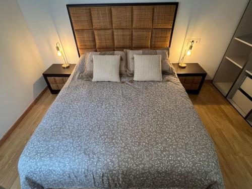 a bedroom with a large bed with two night stands at Cardenas Home Diamante in Santa Fe