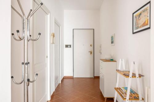 a hallway with a white door and a mirror at Sedie Volanti Apartment with Jacuzzi in Palermo