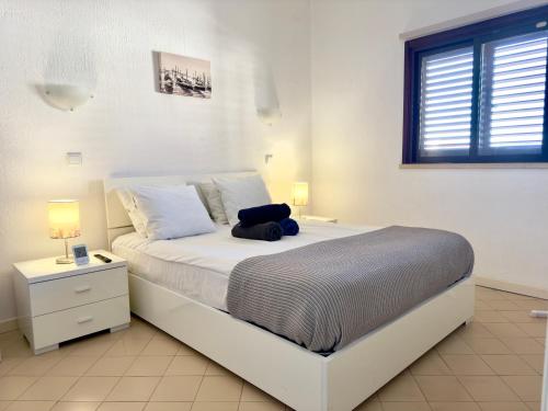 a bedroom with a large bed with a stuffed animal on it at Apartment Les 3 Dauphins in Albufeira in Albufeira