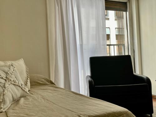 a bedroom with a chair next to a window at The best experience and service in Mendoza