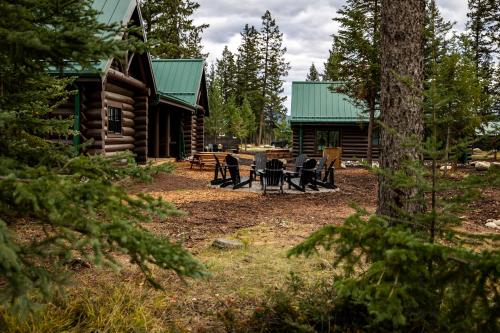 a log cabin with a picnic table in front of it at Pine Bungalows in Jasper