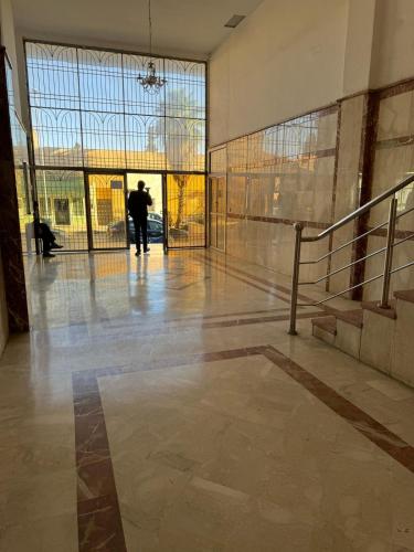 a man walking through a lobby of a building at Appartement Boulevard Mohammed Derfoufi, Oujda in Oujda
