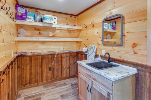 cocina con paredes de madera, lavabo y espejo en Pet-Friendly Houtzdale Hideaway with Gas Grill! 