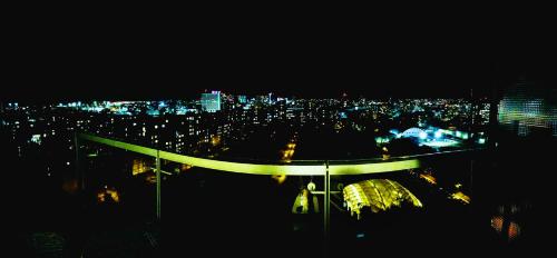 a view of a city skyline at night at Sunny Apartment with amazing Terrace on the 13th floor near City Center in Bratislava