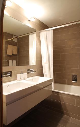 a bathroom with a white sink and a mirror at Schöne Ferienwohnung im Zentrum von St. Moritz in St. Moritz