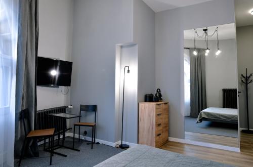 a bedroom with a bed and a table and a desk at BESLEV in Tallinn