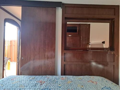 a bedroom with a wooden door and a bed at Sunset Trailer Park RV # 2 in El Suazal
