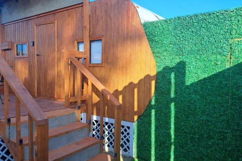 a staircase leading to a house with a green wall at Sunset Trailer Park RV # 2 in El Suazal