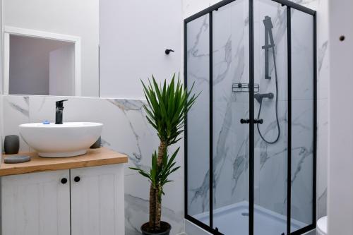 uma casa de banho com uma cabina de duche em vidro e um lavatório. em BESLEV em Taline