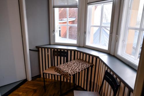 a chair with a leopard seat sitting in front of two windows at BESLEV in Tallinn