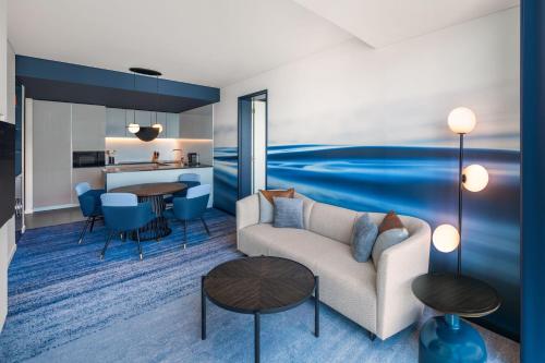 a living room with a couch and a table at W Sydney in Sydney
