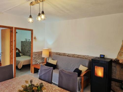 a living room with a couch and a fireplace at Finca Llambrich in L'Ametlla de Mar