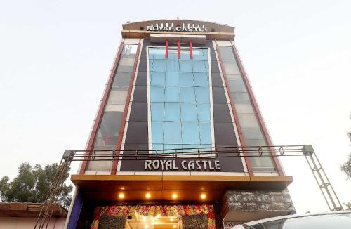 a tall building with a sign on top of it at OYO Flagship 78167 Hotel Royal Castle in Kaliānpur