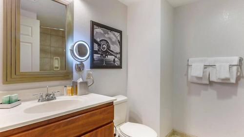 a bathroom with a sink and a toilet and a mirror at Viva Las Vegas! Bluegreen Club 36 in Las Vegas