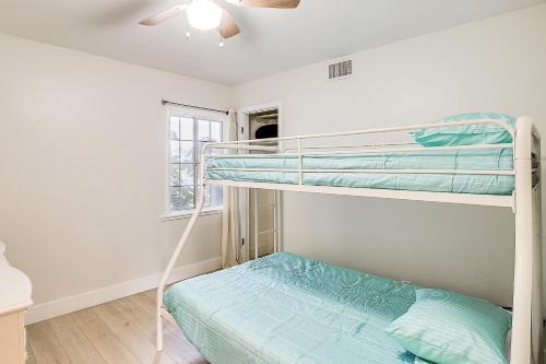 a bedroom with two bunk beds and a window at Buena Park Home with Patio about 9 Mi to Disneyland! in Buena Park
