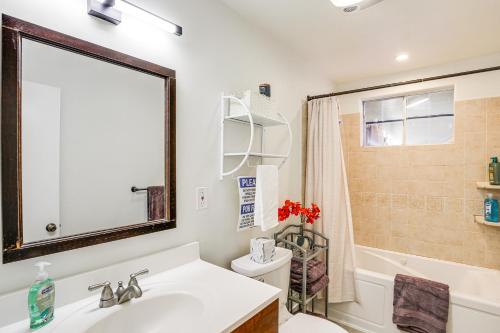 a bathroom with a sink and a tub and a toilet at Buena Park Home with Patio about 9 Mi to Disneyland! in Buena Park