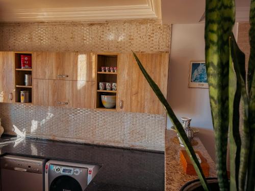 a kitchen with wooden cabinets and a counter top at Hammam Antistress in Sousse