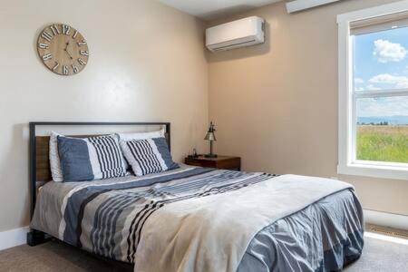 a bedroom with a bed with a clock on the wall at Teton Crest Lodge Sleeps 24 Ideal Reunion Spot in Driggs