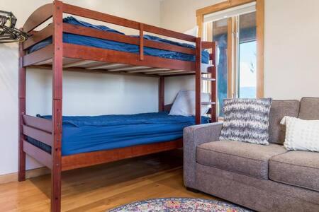 a living room with bunk beds and a couch at Teton Crest Lodge Sleeps 24 Ideal Reunion Spot in Driggs