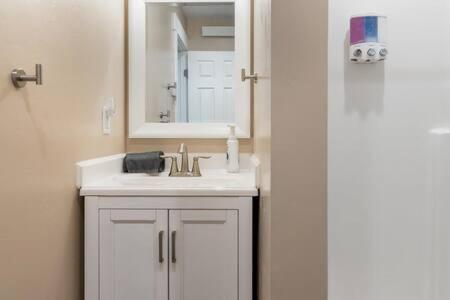 a white bathroom with a sink and a mirror at Teton Crest Lodge Sleeps 24 Ideal Reunion Spot in Driggs