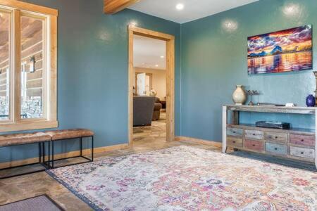a living room with blue walls and a large rug at Teton Crest Lodge Sleeps 24 Ideal Reunion Spot in Driggs