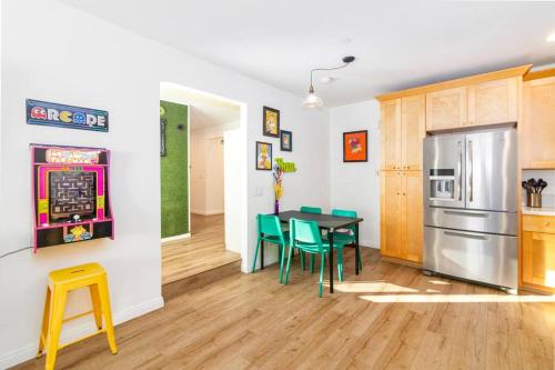 a kitchen and dining room with a table and chairs at Colorful Home 3Bd 2Ba, Sleeps8, 1block to Univ., Pac-man, BBQ, FirePit in Redlands