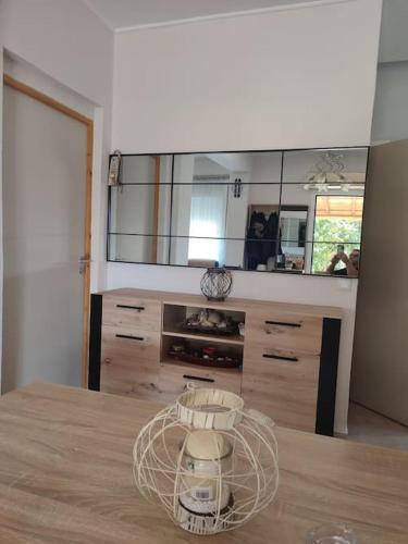 a kitchen with a large mirror and a wooden table at ofrynio kavalas Martin House in Karianí