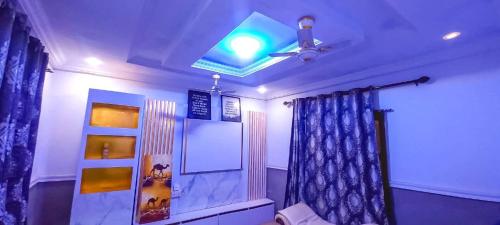 a room with a ceiling fan and a blue curtain at CRE8 Homes in Tamale