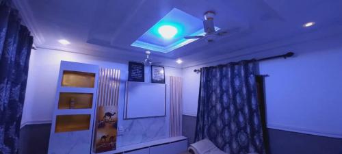 a living room with a ceiling fan and a window at CRE8 Homes in Tamale