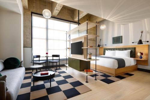 a bedroom with a bed and a checkered floor at Switch House Hotel in Philadelphia