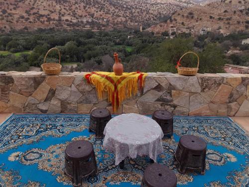a table with a vase sitting on top of a table at RISA FAMILY in Taroudant