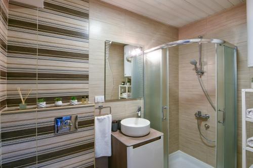 a bathroom with a sink and a shower at City Center Apartment Uzice in Užice
