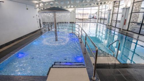 a large indoor swimming pool with a water fountain at 519 Family Caravan at Golden Gate Holiday Centre, Sleeps 6 in Abergele