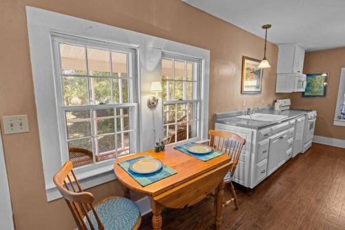a kitchen with a table and chairs and a sink at Historic Hartsfield House in New Bern