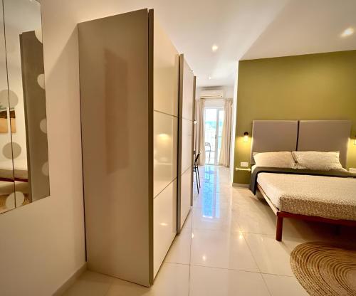 a bedroom with a bed and a couch at Village Getaway - Mgarr Malta in Mġarr