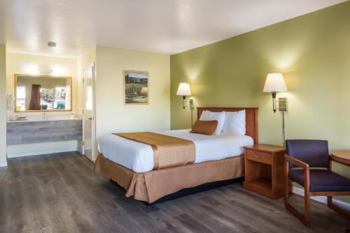 a hotel room with a bed and a bathroom at Americas Best Value Inn Santa Rosa in Santa Rosa