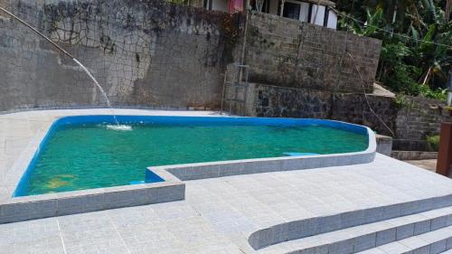 Pousada do Toninho في بيرويبي: مسبح مع نافورة ماء