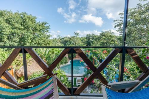 a view from the balcony of a resort with two chairs at Casa Delfín Tulum in Macario Gomez