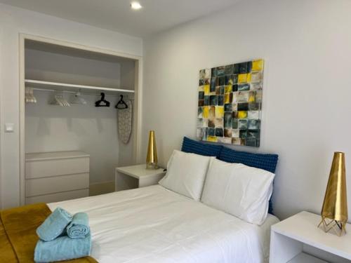 a bedroom with a large white bed and two tables at Fantastic 1 Bedroom Apartment at Roma Avenue - 1B in Lisbon
