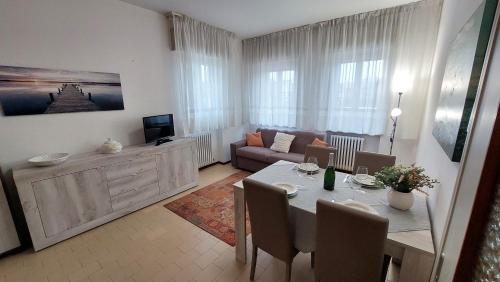 a living room with a table and a couch at Verbena Holiday Apartment in Lazise