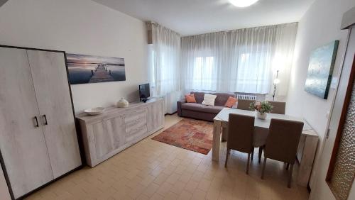 a living room with a table and a couch at Verbena Holiday Apartment in Lazise