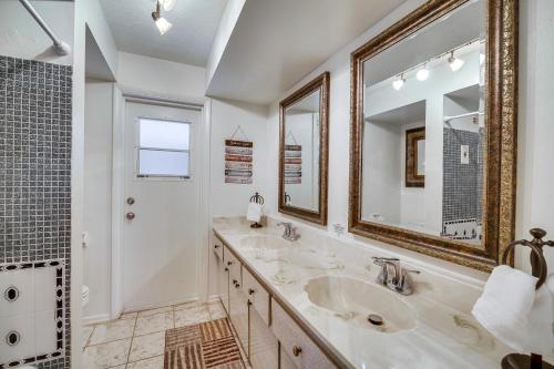 a bathroom with two sinks and a shower at Centrally Located Merritt Island Home Pool, Porch in Merritt Island