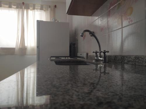 a bathroom with a sink and aaucet at La Victoria in Rosario
