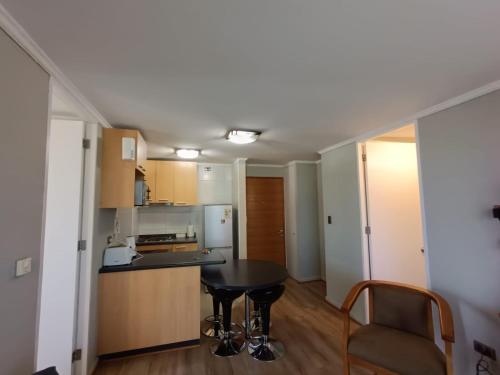a kitchen with a table and a counter top at APART LOMAS DE SAN ANDRES concepción in Concepción