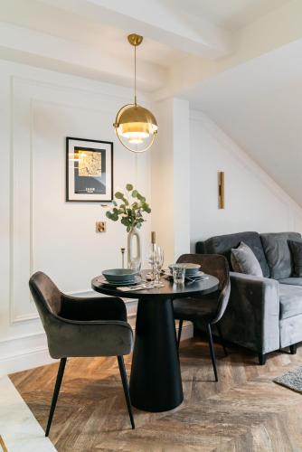 a living room with a table and a couch at Central Palace - LoftAffair Collection in Kraków