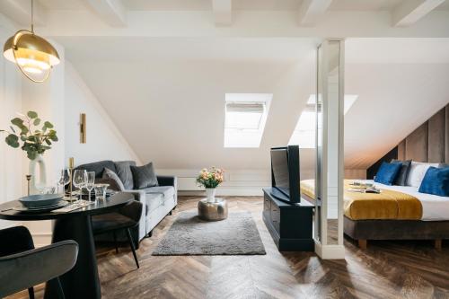 a living room with a couch and a bed at Central Palace - LoftAffair Collection in Kraków